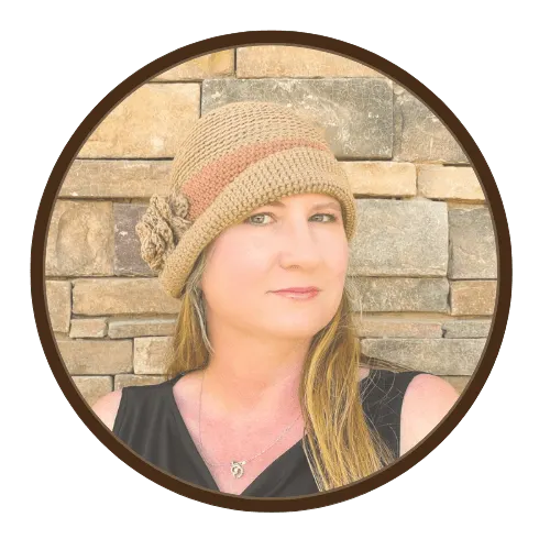 Handmade crochet cloche hat with flower embellishment in taupe and beige, modeled in a modern vintage French chic style.