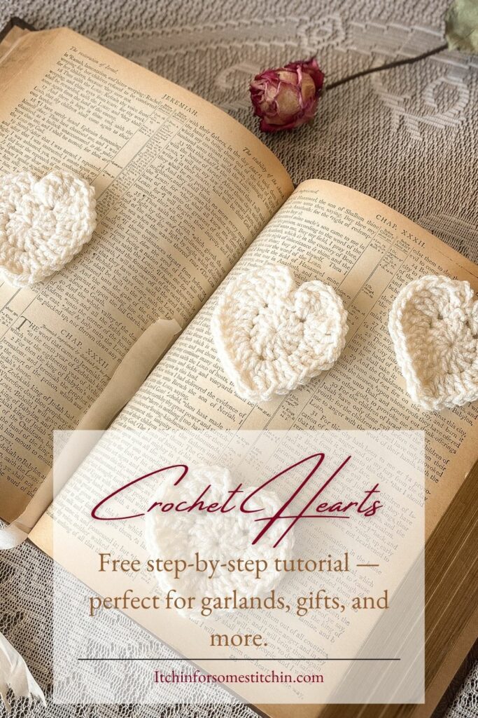 A soft, vintage-style image showing a crochet heart tutorial with a finished heart, yarn, and a printed pattern sheet styled on a cozy neutral surface. Ideal for beginners looking to learn how to crochet a heart with easy, visual instructions.