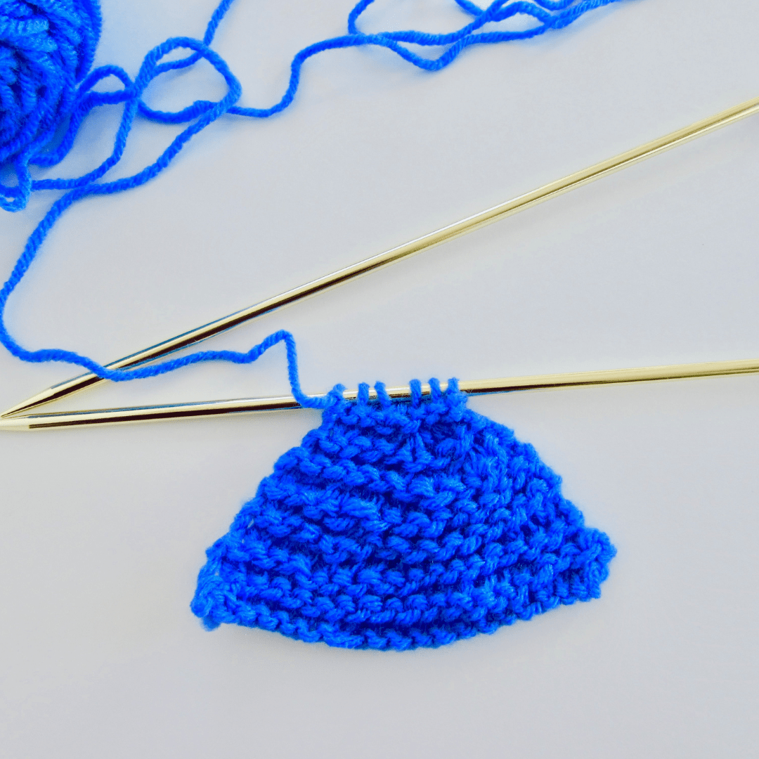 Knitting Decreases demonstrated on blue yarn