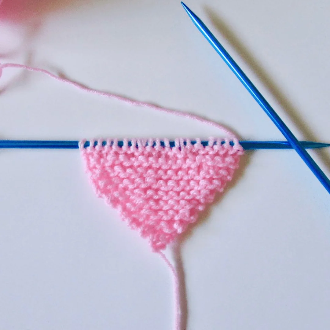 Piece of knitted fabric with each row increased by adding one stitch