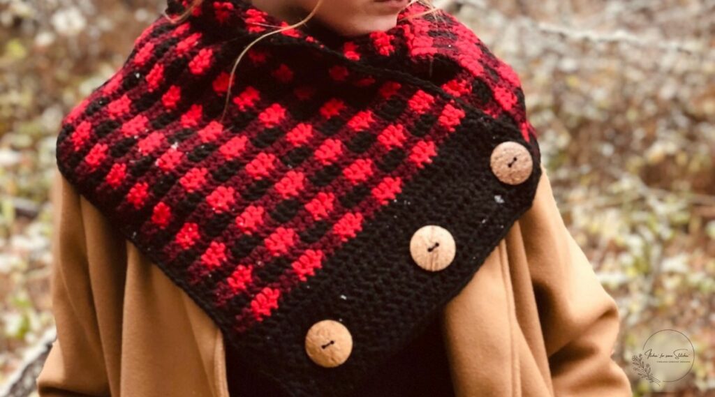 Buffalo Plaid Crochet Cowl Pattern featuring  red and black plaid crochet stitches with decorative buttons and a cozy autumn-inspired design.