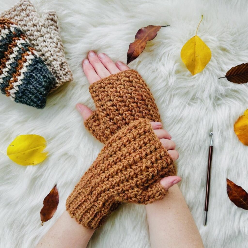 Textured crochet fingerless mittens with ribbed cuffs and fitted thumb openings.
