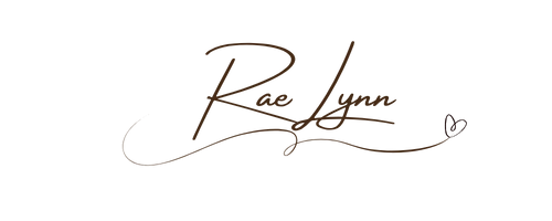 Hand written signature of RaeLynn with a heart in brown ink