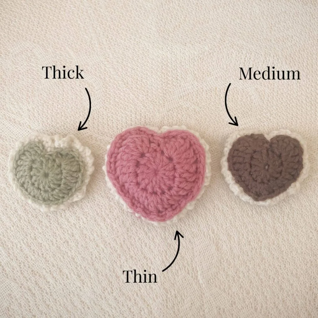 Three puffed crochet hearts in a row showing different border thicknesses—labeled Thick, Medium, and Thin—to demonstrate how seam placement affects the final look of the border.